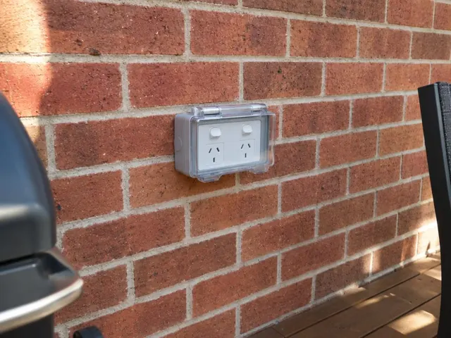 Outdoor double power point on a brick exterior wall with a clear weatherproof cover in Cooks Hill